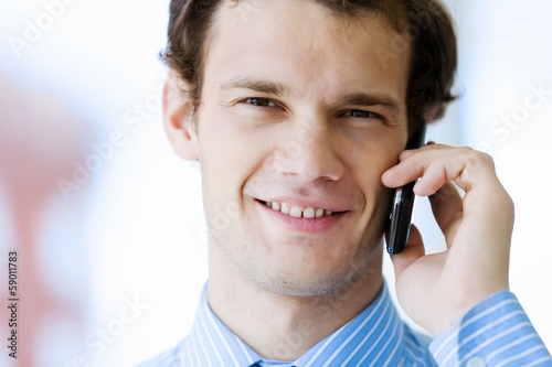 Photo: Businessman speaking mobile phone Businessman speaking mobile phone
