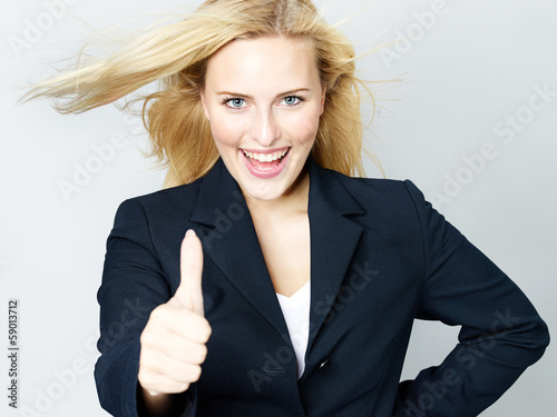 Photo: Successful business woman shows thumb up Successful business woman shows thumb up