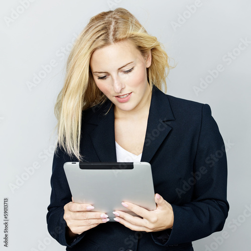 Photo: Business woman reading on touchpad Business woman reading on touchpad