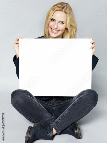 Photo: Woman presenting blackboard with copyspace Woman presenting blackboard with copyspace