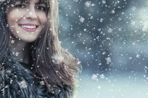 Photo: Portrait of a smile young woman in a winter snow day Portrait of a smile young woman in a winter snow day