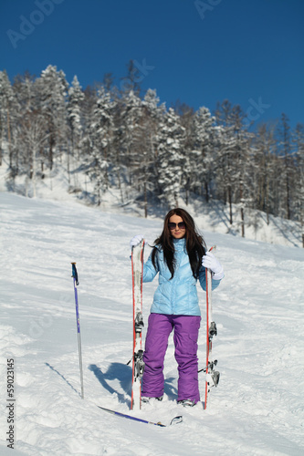 Photo: Girl with the skis at the ski slope Girl with the skis at the ski slope