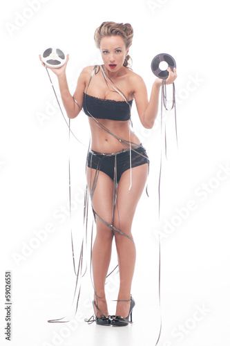 Photo: Attractive woman with an audio retro bobbins Attractive woman with an audio retro bobbins