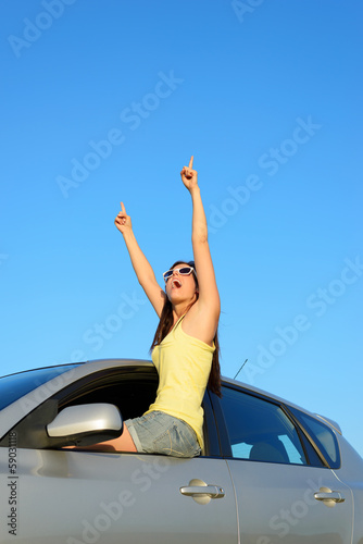 Photo: Successful female driver pointing Successful female driver pointing