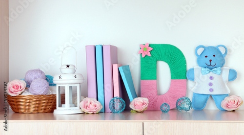 Photo: Shelf decorated with handmade knit letter Shelf decorated with handmade knit letter