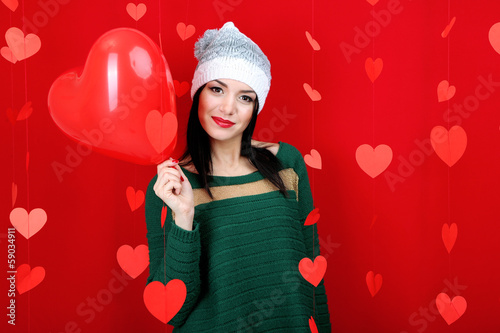 Photo: Attractive young woman with balloon on Valentine Day Attractive young woman with balloon on Valentine Day