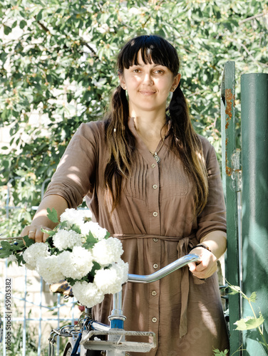 Photo: Smiling woman out collecting spring blossom Smiling woman out collecting spring blossom
