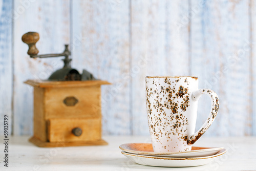 Photo: latte coffee cup with Nostalgic coffee grinder on background latte coffee cup with Nostalgic coffee grinder on background