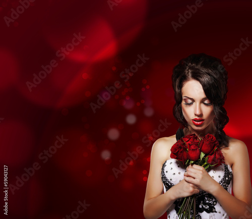 Photo: Dreamy Woman with Bouquet of Flowers over Purple Background Dreamy Woman with Bouquet of Flowers over Purple Background