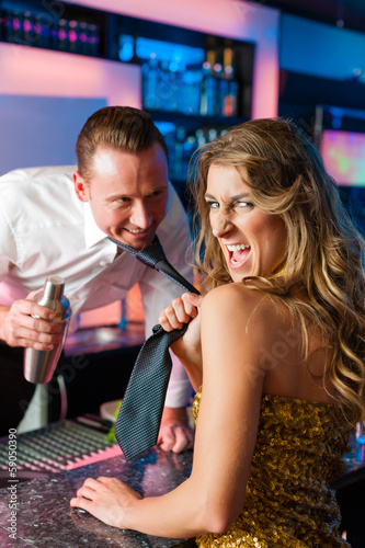Photo: Woman dragging barkeeper in club or bar Woman dragging barkeeper in club or bar