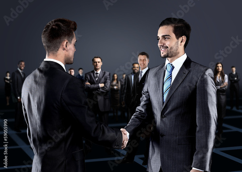 Photo: Portrait of young business people. Handshake Portrait of young business people. Handshake