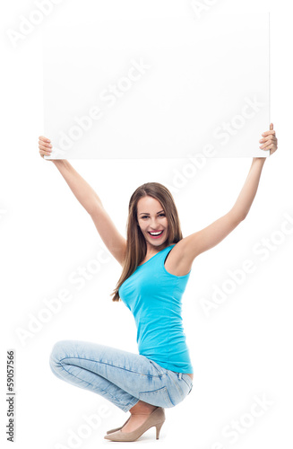 Photo: Attractive young woman with blank sign Attractive young woman with blank sign