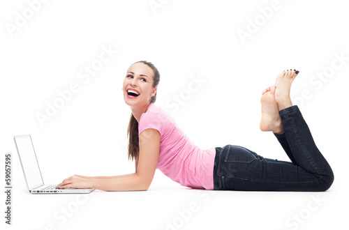 Photo: Woman with her laptop lying on the floor Woman with her laptop lying on the floor