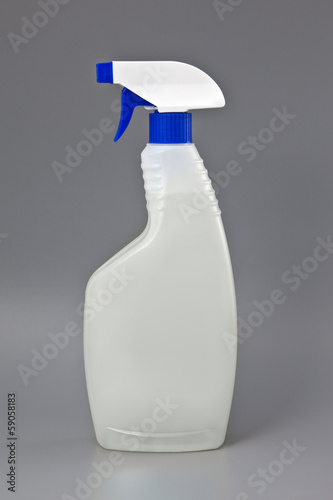 Photo: Transparent detergent plastic spray bottle isolated on gray Transparent detergent plastic spray bottle isolated on gray