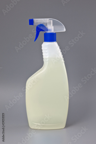 Photo: Transparent detergent plastic spray bottle isolated on gray Transparent detergent plastic spray bottle isolated on gray