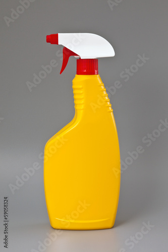Photo: Yellow detergent plastic spray bottle isolated on gray Yellow detergent plastic spray bottle isolated on gray
