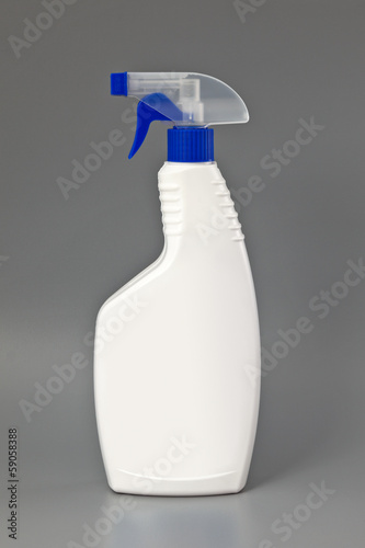 Photo: White detergent plastic spray bottle Isolated on gray White detergent plastic spray bottle Isolated on gray