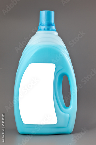 Photo: Transparent detergent plastic bottle isolated on gray Transparent detergent plastic bottle isolated on gray