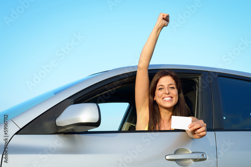 Photo: Woman passing car driving license test Woman passing car driving license test