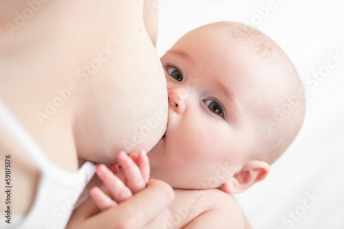 Photo: mother breast feeding her infant baby girl mother breast feeding her infant baby girl