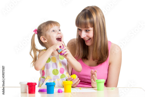 Photo: kid girl and mother playing colorful clay toy kid girl and mother playing colorful clay toy