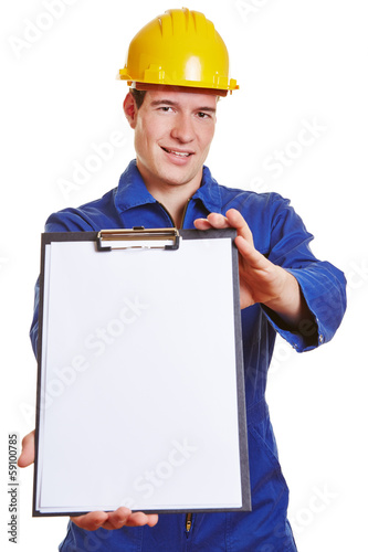 Photo: Construction worker offering clipboard Construction worker offering clipboard
