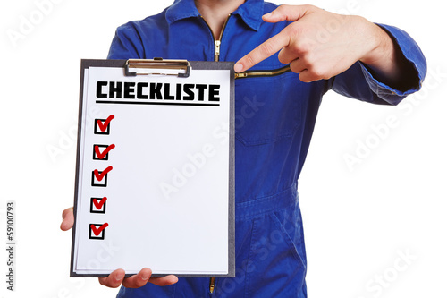 Photo: Hand of a worker showing checklist Hand of a worker showing checklist