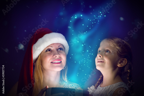 Photo: mother and daughter opened a box with a gift mother and daughter opened a box with a gift