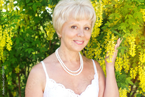 Photo: Beautiful adult woman with flowers Beautiful adult woman with flowers