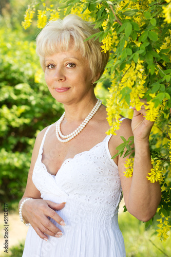 Photo: Beautiful adult woman with flowers Beautiful adult woman with flowers