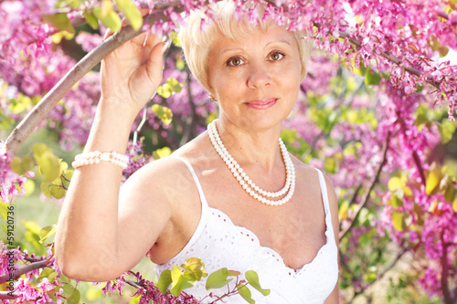 Photo: Beautiful adult woman with flowers Beautiful adult woman with flowers