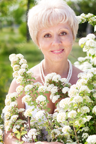 Photo: Beautiful adult woman with flowers Beautiful adult woman with flowers