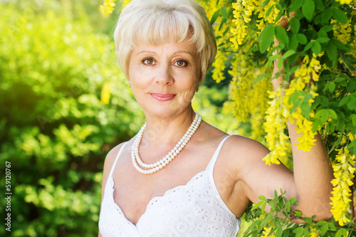 Photo: Beautiful adult woman with flowers Beautiful adult woman with flowers