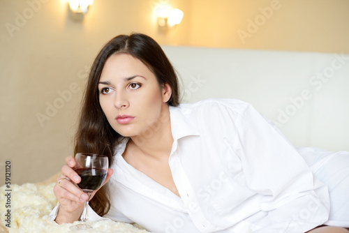 Photo: brunette with glass of wine brunette with glass of wine