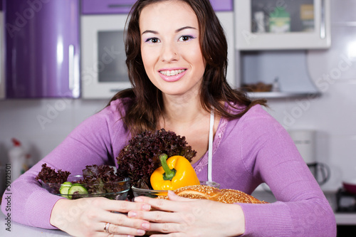 Photo: Pretty woman cooking food in the kitchen Pretty woman cooking food in the kitchen