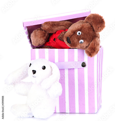 Photo: Textile box with toys, isolated on white Textile box with toys, isolated on white