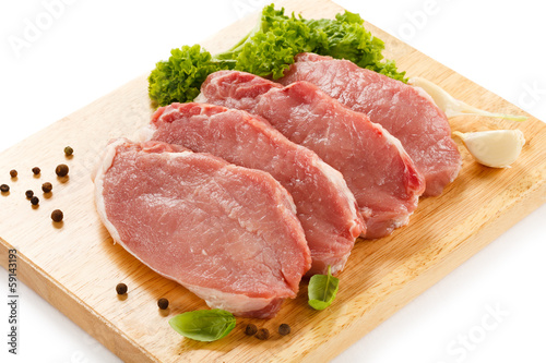 Photo: Raw pork on cutting board and vegetables Raw pork on cutting board and vegetables