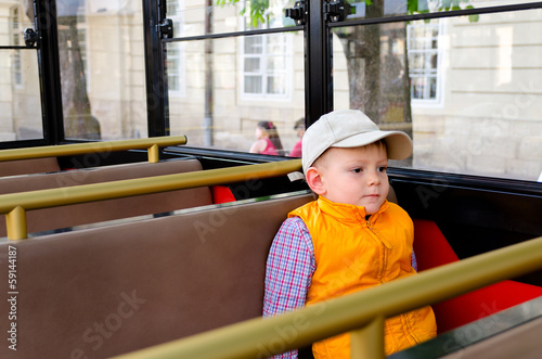 Photo: Little boy sitting alone in a bus Little boy sitting alone in a bus