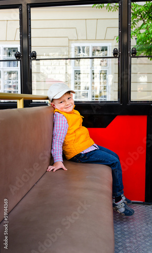 Photo: Little boy sitting alone in a bus Little boy sitting alone in a bus
