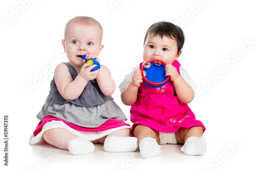 Photo: Funny babies girls with musical toys Funny babies girls with musical toys
