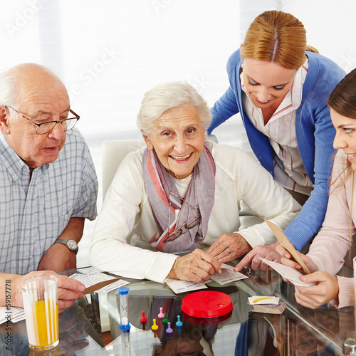Photo: Family with senior couple playing games Family with senior couple playing games