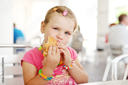 Photo: little girl with hamburger little girl with hamburger