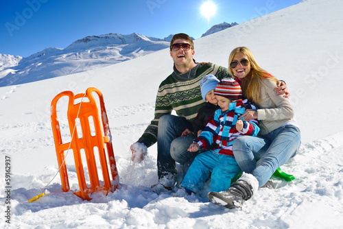 Photo: family having fun on fresh snow at winter vacation family having fun on fresh snow at winter vacation