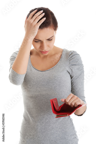 Photo: Beautiful casual woman with empty wallet, worrying. Beautiful casual woman with empty wallet, worrying.