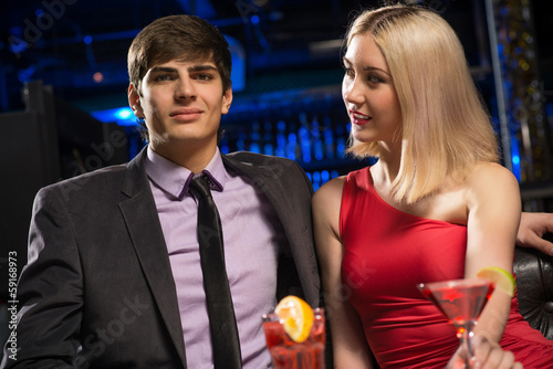 Photo: Young couple talking in a nightclub Young couple talking in a nightclub