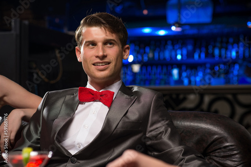 Photo: portrait of a man in a nightclub portrait of a man in a nightclub