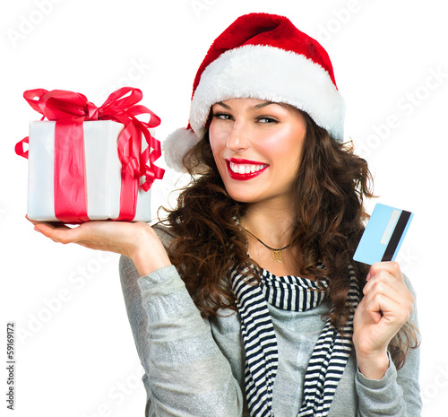 Photo: Christmas Shopping. Happy Smiling Woman with Gift Box Christmas Shopping. Happy Smiling Woman with Gift Box