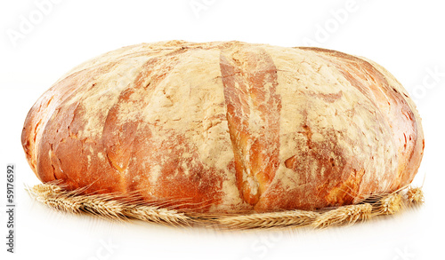 Photo: Large loaf of traditionally baked bread isolated on white Large loaf of traditionally baked bread isolated on white