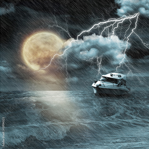 Photo: Boat in storm evening on ocean and the moon Boat in storm evening on ocean and the moon