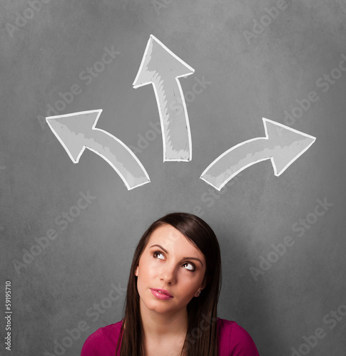 Photo: Young woman thinking with arrows above her head Young woman thinking with arrows above her head